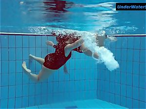 two steaming teens underwater